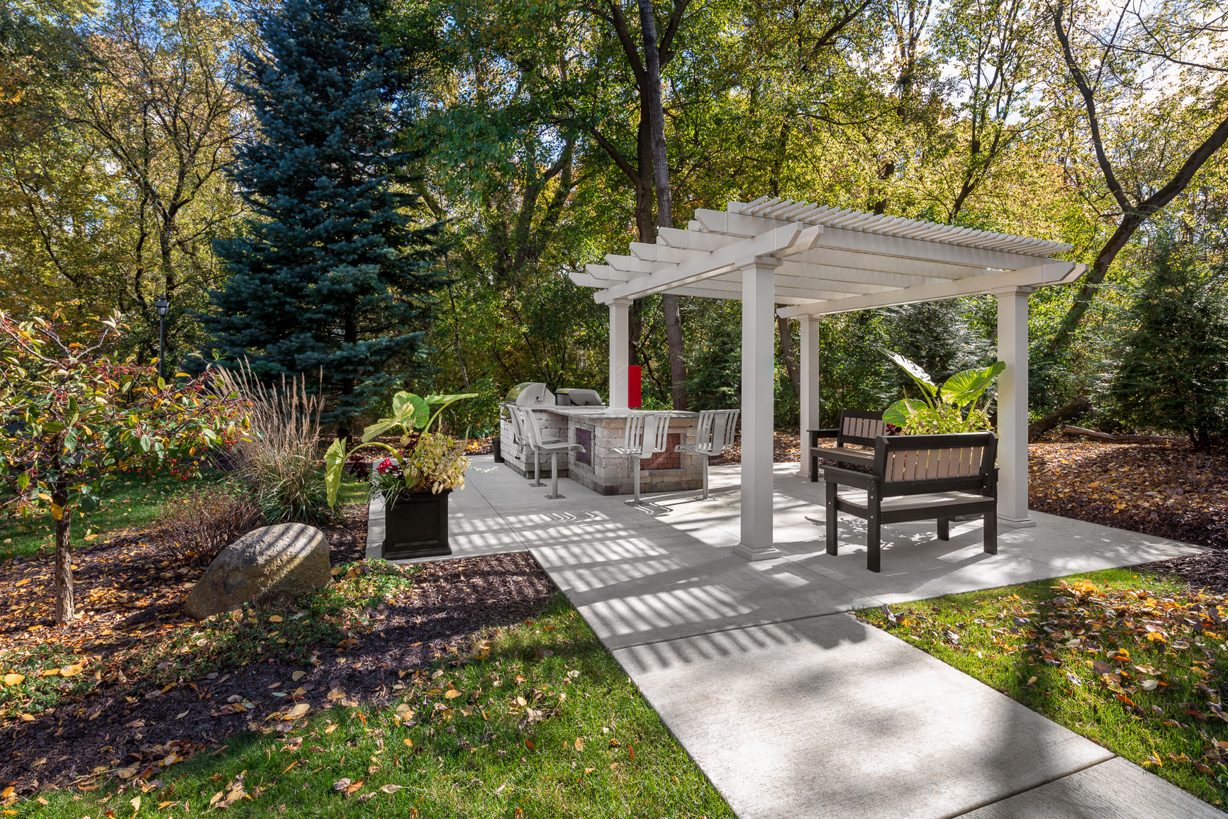 a patio with a pavilion and a table and chairs