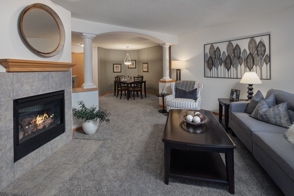 a living room with a fireplace and a couch and a table
