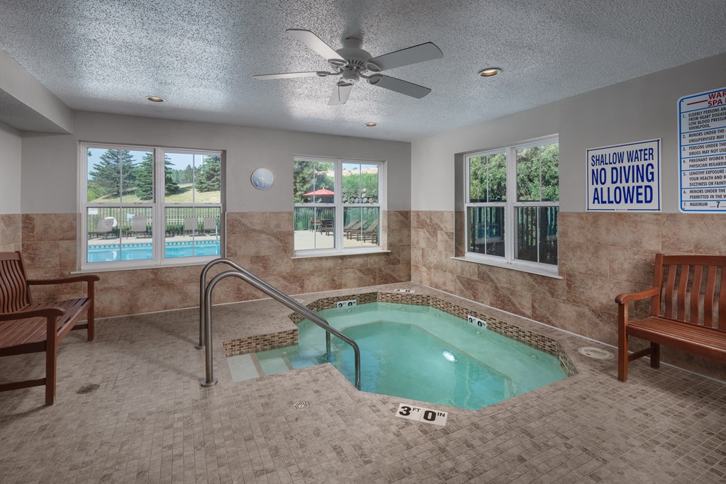 a spa area with a pool and a ceiling fan