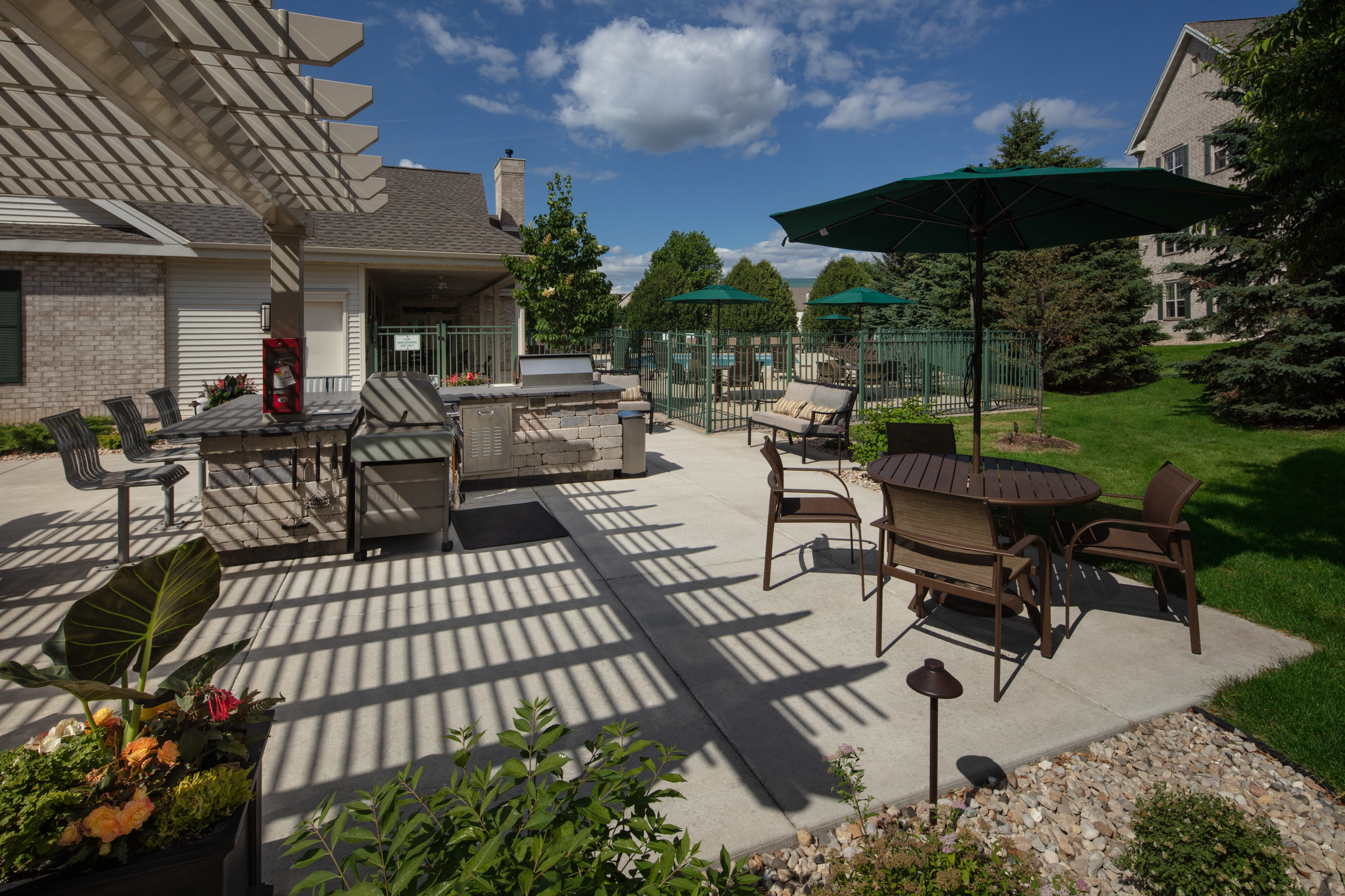 a patio with tables and chairs and umbrellas