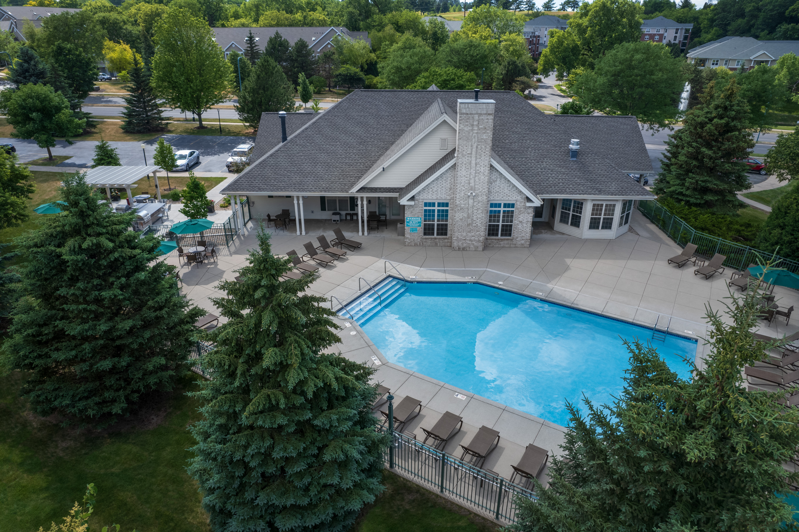 a aerial view of a swimming pool in front of a house