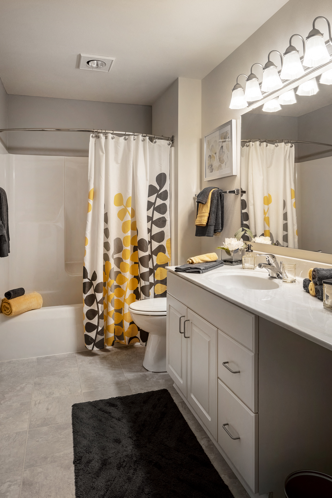 a bathroom with a sink and a toilet and a shower curtain