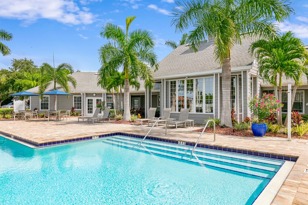 a swimming pool with a house in the background