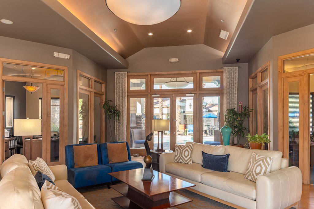 a living room filled with furniture and a large window