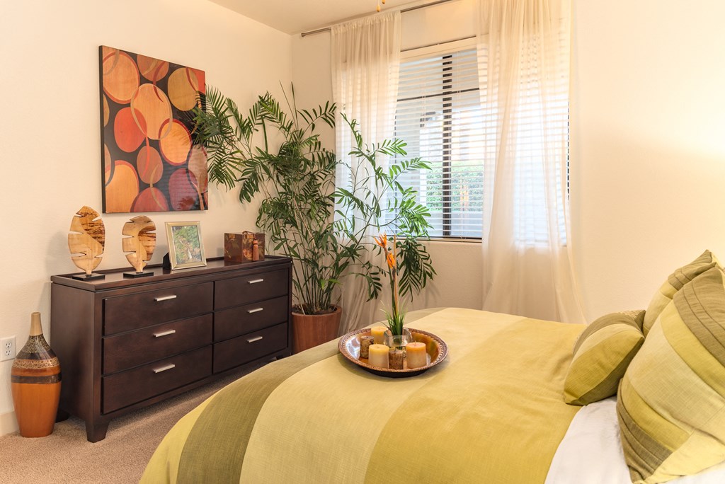 a bedroom with a large bed and a dresser