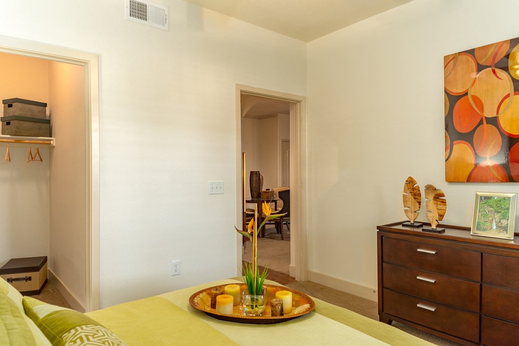 a bedroom with a bed and a dresser