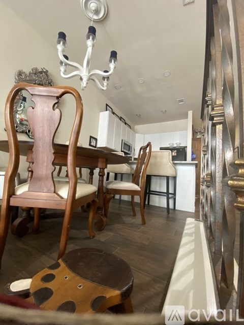 A dining room with a wooden table and chairs.