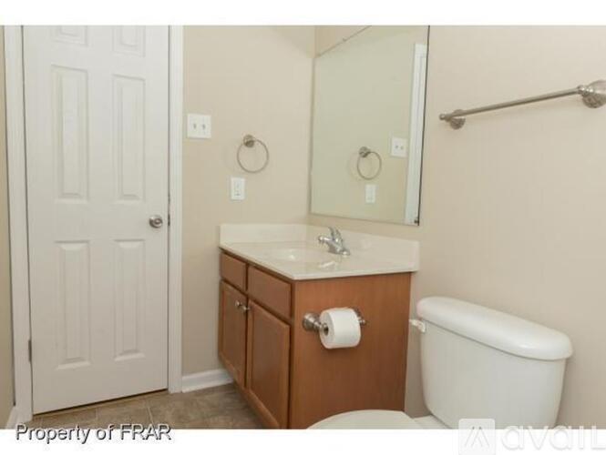 A white toilet sits next to a sink in a small bathroom.