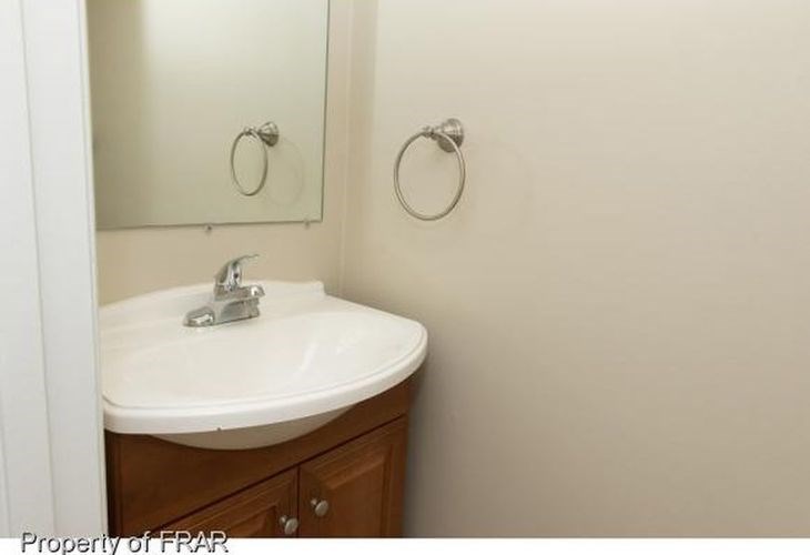 A white sink in a small bathroom.
