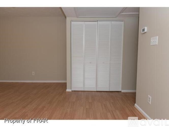 A room with a sliding door and wooden flooring.
