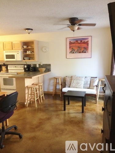 A kitchen with a table and chairs in the middle of the room.