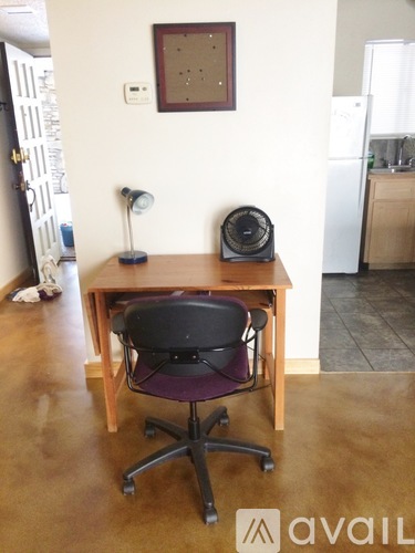 A small table with a chair and a speaker on it.