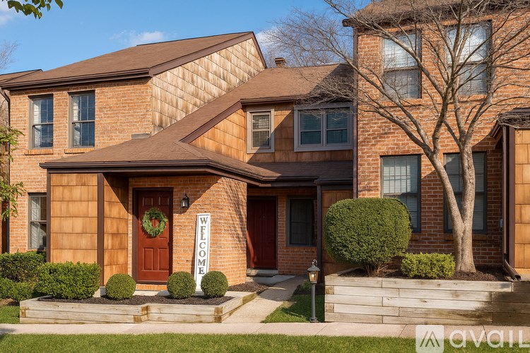 A house with a red door and a brick wall.
