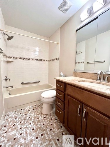 A bathroom with a toilet, sink, and shower.