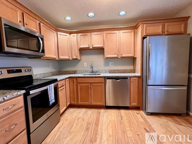 A kitchen with wooden cabinets and stainless steel appliances.
