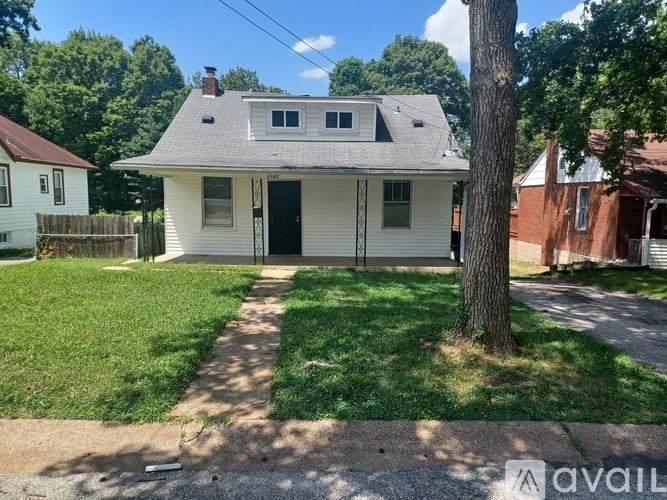 A house with a tree in front of it.