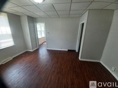 A room with wooden floors and white walls.