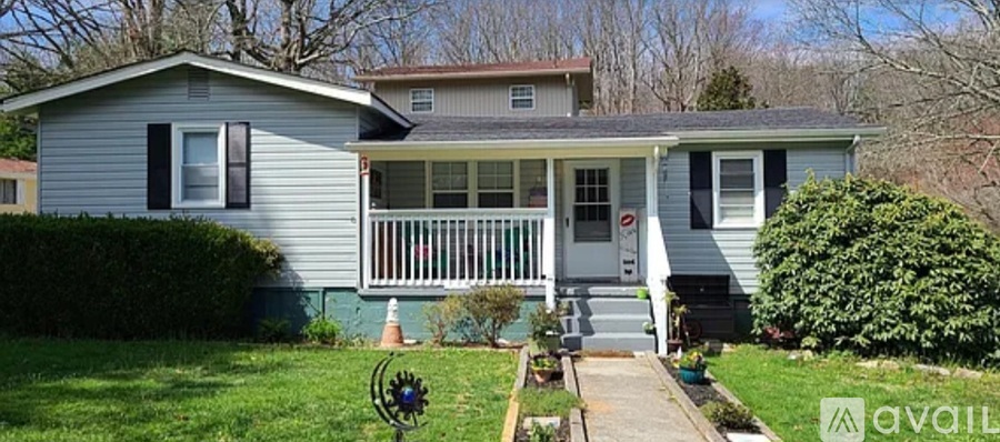 A house with a porch and a front yard.