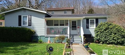 A house with a porch and a front yard.