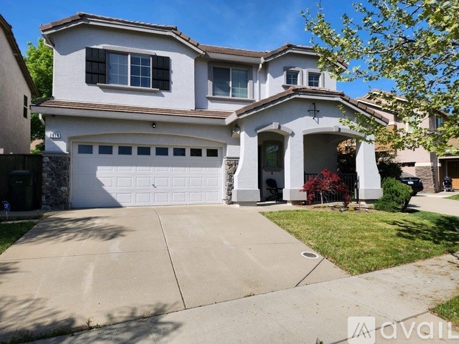 A two-story house with a garage is for sale.