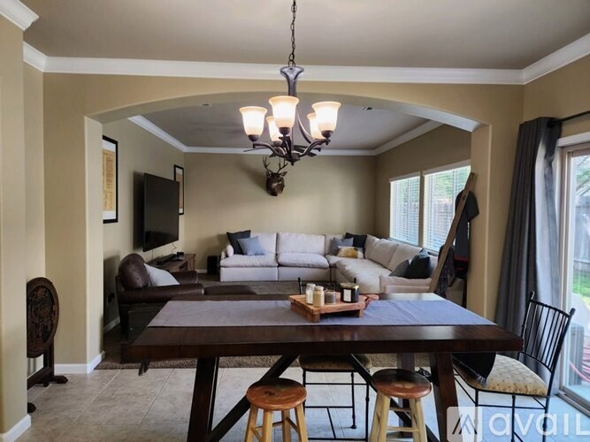A dining room with a wooden table and chairs.
