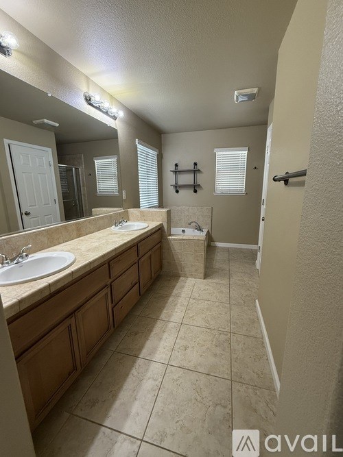 A bathroom with a sink, mirror, and toilet.