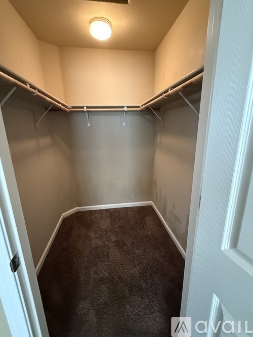 A small, empty room with a carpeted floor and white walls.