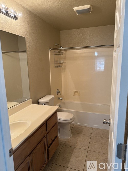 A bathroom with a toilet, sink, and bathtub.