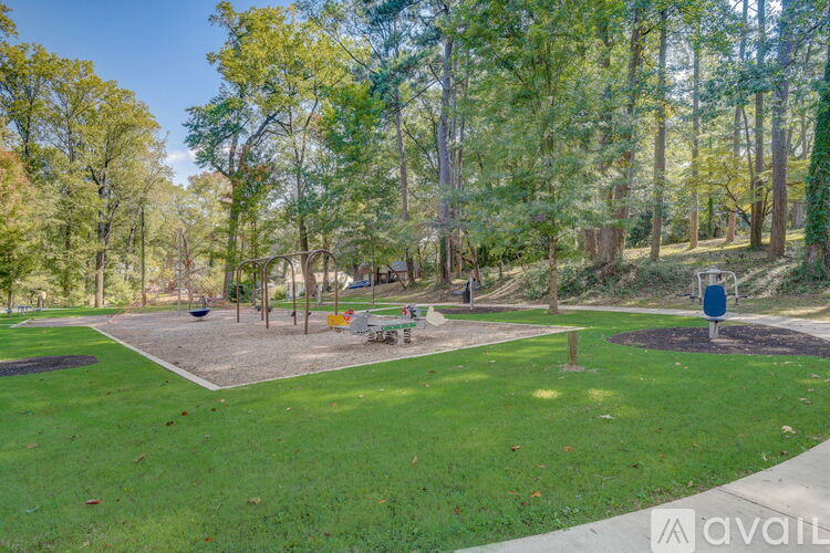 A park with a playground and trees.