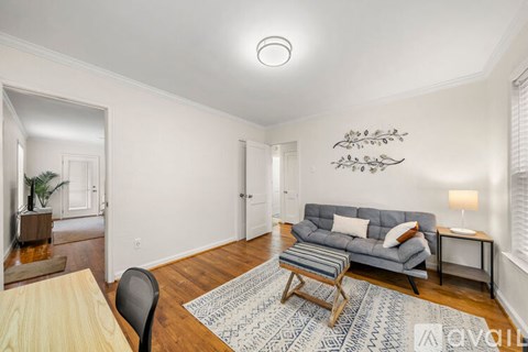 A living room with a grey couch and a wooden coffee table.