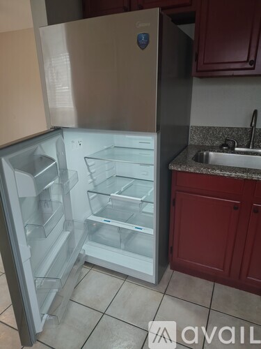 A room with a glass door and tiled floor.