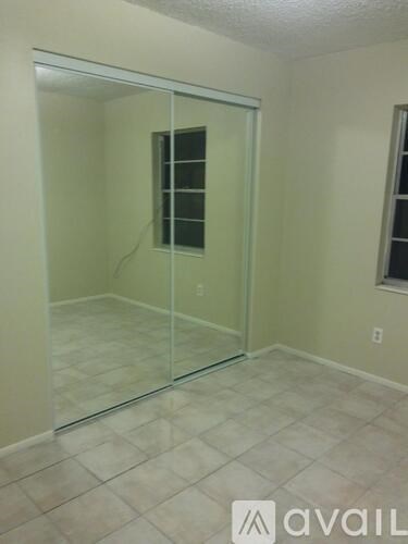 A room with a glass door and tiled floor.