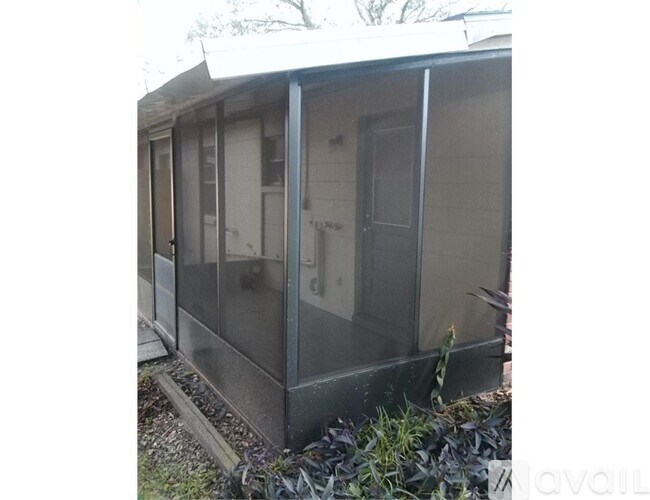 A glass enclosed booth with a door and windows.