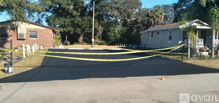 A residential street with a yellow caution tape across it.