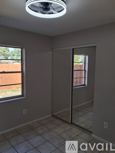 A white bathroom with a toilet, tub, and towel rack.