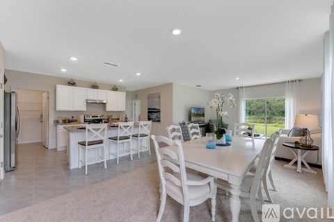 A modern kitchen with a dining table and chairs.