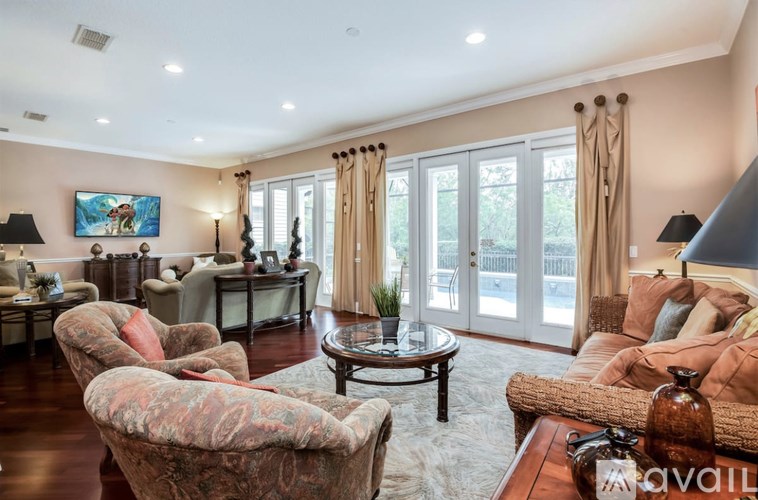 A living room with a couch, armchairs, and a coffee table.