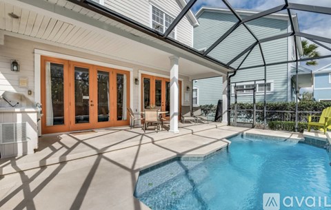 A pool in a backyard with a glass roof.