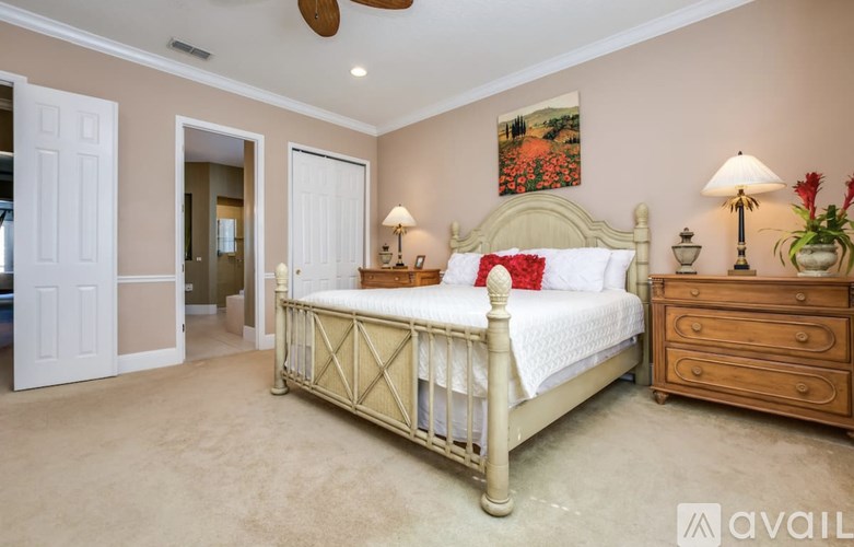 A bedroom with a bed, dresser, and ceiling fan.