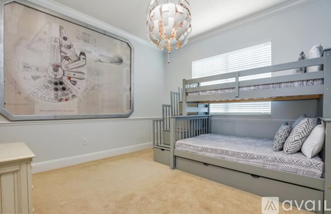 A room with a large Star Wars poster on the wall and a bunk bed.