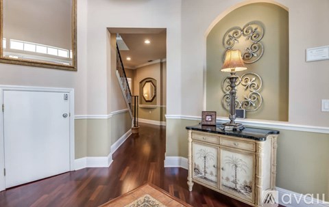 A room with a wooden floor and a white door.