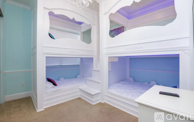 A white bunk bed with a mirror above it.