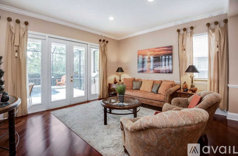 A living room with a couch, chairs, and a coffee table.