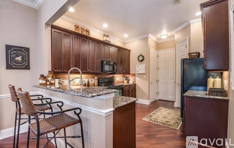 A kitchen with brown cabinets and a white island.