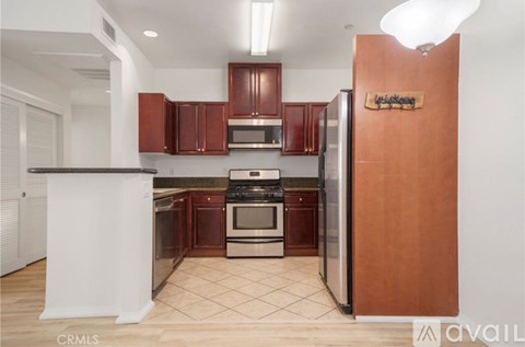 A kitchen with brown cabinets and a white island.