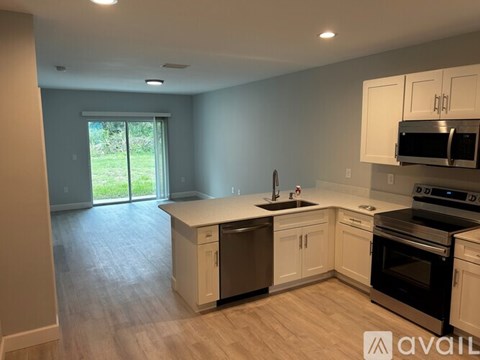 A kitchen with white cabinets and stainless steel appliances.