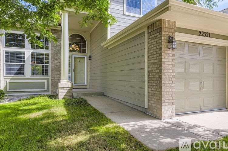 A house with a garage and a driveway is numbered 22321.