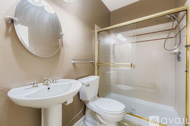 A bathroom with a white sink and toilet.