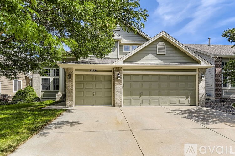 A house with a garage and a driveway in front.