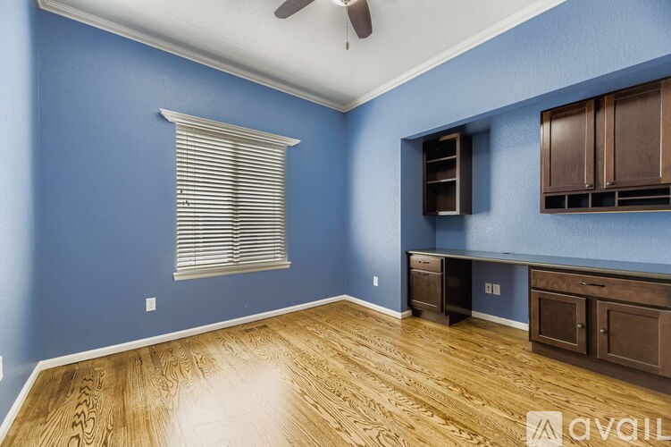 A room with blue walls and wooden flooring.
